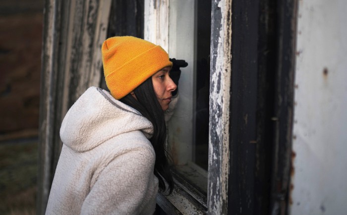 woman-looking-through-frame-cabin-window